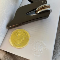 Zodiac motif embosser paired with stylish clips for elegant book and document marking