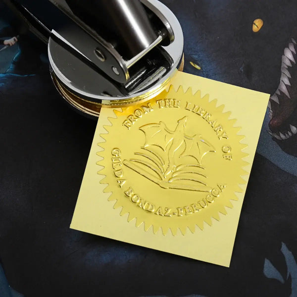 Gold embossed Ex Libris seal with dragon and open book design, personalized text reading &