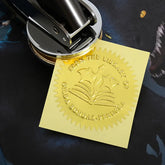 Gold embossed Ex Libris seal with dragon and open book design, personalized text reading &