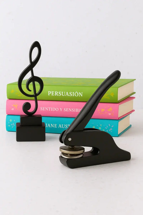 Black press with music note design on top of books